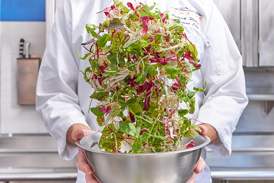 A chef preparing a salad